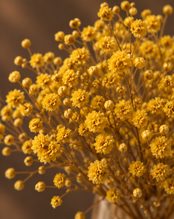 Close-up of Cherivo Honeydrop vase amber tone and yellow flowers